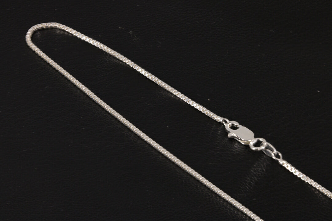 Sterling silver box chain on a black background