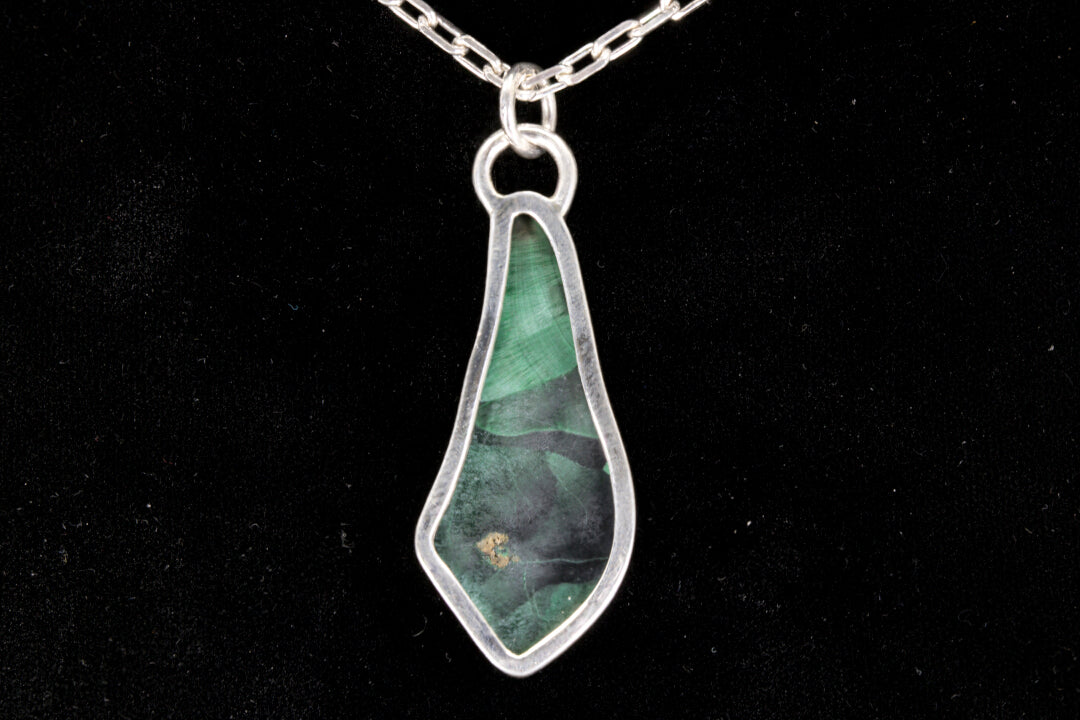 Fibrous Malachite Pendant set in sterling silver on a black background back view