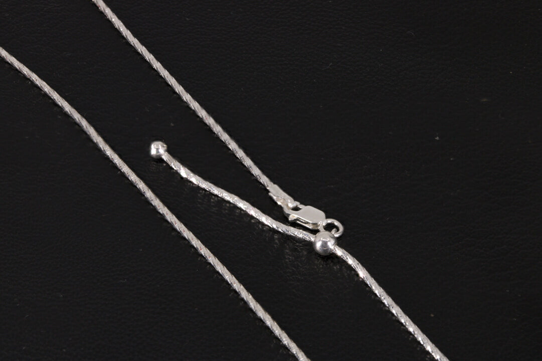 Adjustable Sterling Silver Chain on a black background
