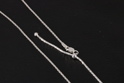 Adjustable Sterling Silver Chain on a black background