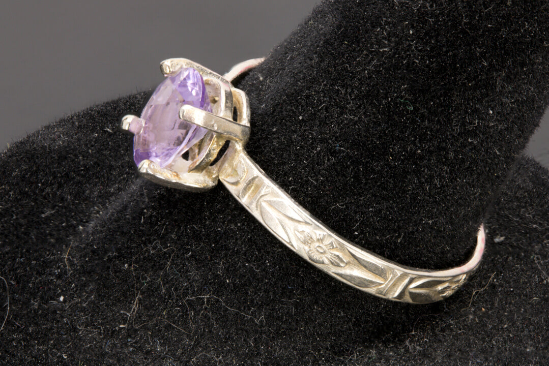 Faceted oval cut Amethyst ring set in sterling silver with a flower ring band, size 8.5 right side view