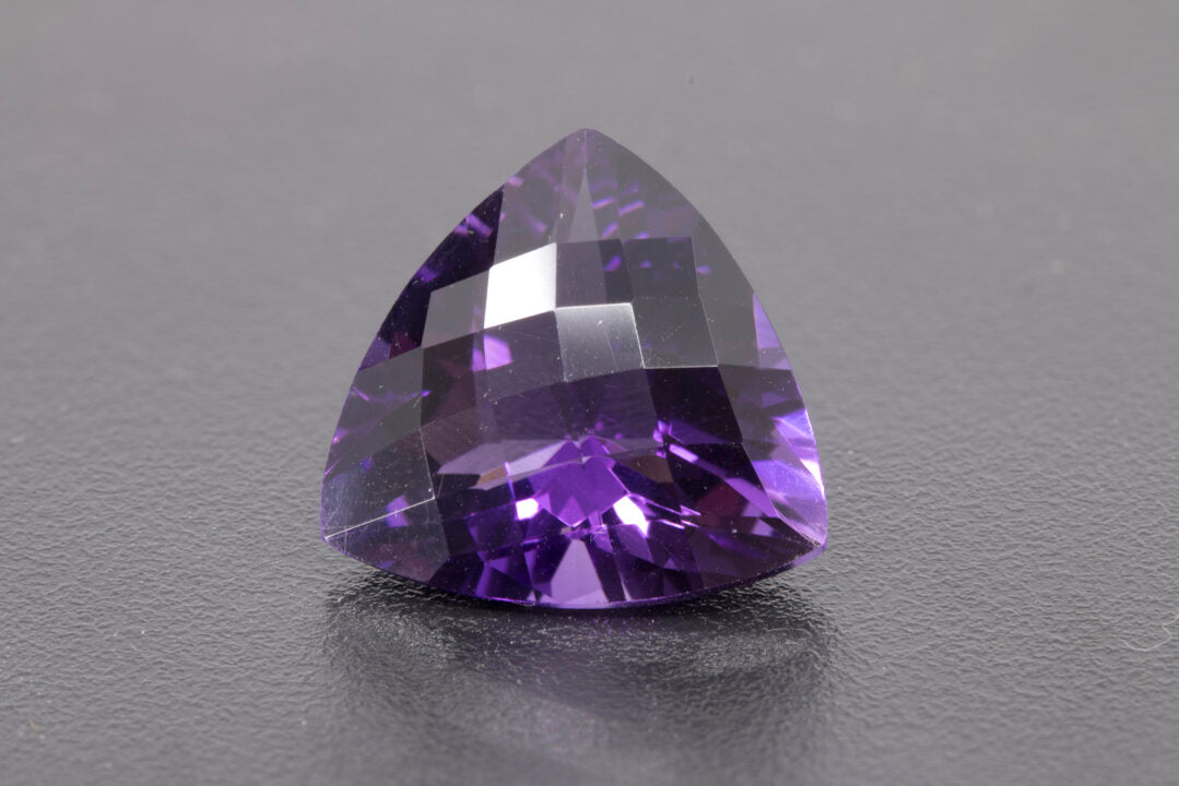 Faceted Trillion checker cut Amethyst, size 11.7 ct. and is 17.9 mm across each side, front view