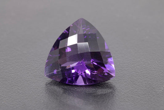 Faceted Trillion checker cut Amethyst, size 11.7 ct. and is 17.9 mm across each side, front view