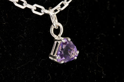 Amethyst trillion facet set in a sterling silver pendant left side photo