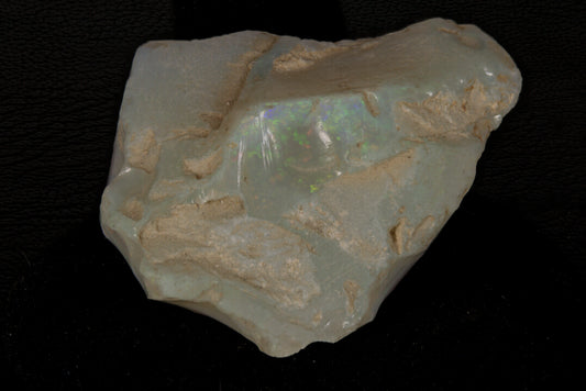 Rough Andamooka Opal from Australia on a black background