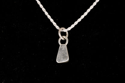 The back of a Blue faced Australian Boulder Opal set in sterling silver on a silver chain on a black background