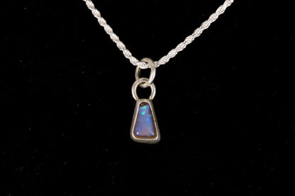 Blue faced Australian Boulder Opal set in sterling silver on a silver chain on a black background