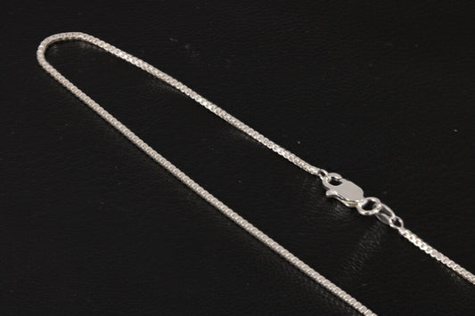 Sterling silver box chain on a black background