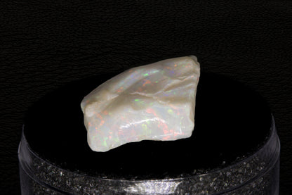 Coober Pedy rough opal setting on a black stand