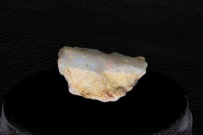Coober Pedy rough opal setting on a black stand