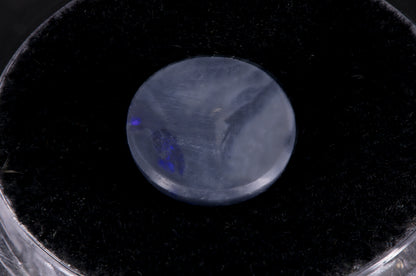 Round Lightning Ridge Black Opal on a black background back view
