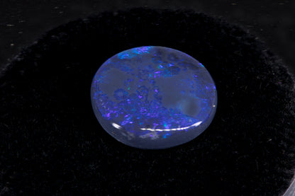 Round Lightning Ridge Black Opal on a black background