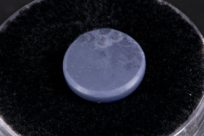 Lightning Ridge Black Opal with purple flash on a black background back view