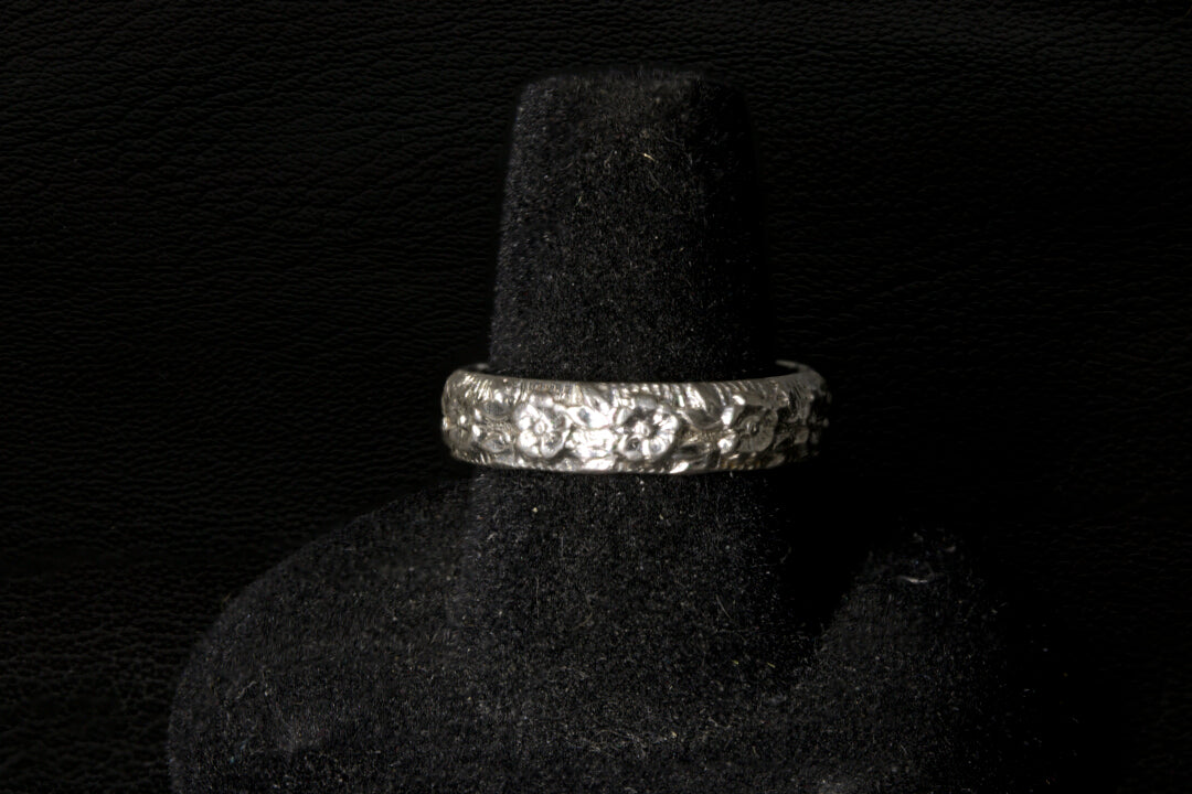 Silver ring with a large Opal gemstone on a black stand back view