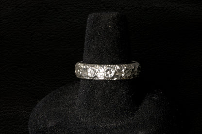 Silver ring with a large Opal gemstone on a black stand back view