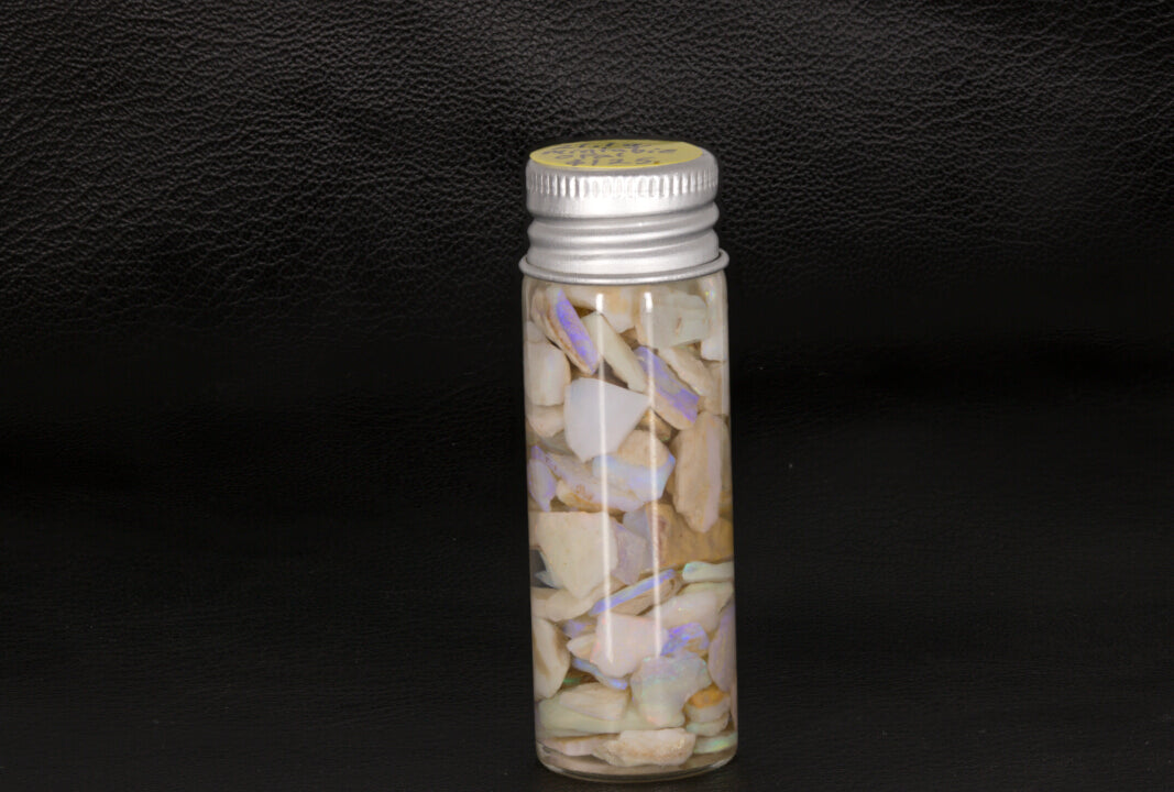Mintabie rough Opal chips and small stones in a small jar
