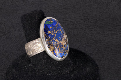 Blue Azurite Oval Ring with decorative flower ring band set in sterling silver on a black background