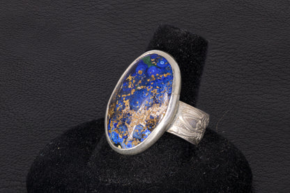 Blue Azurite Oval Ring with decorative flower ring band set in sterling silver on a black background