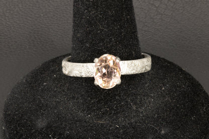 Peach Tourmaline oval facet set in a decorative sterling silver ring band front photo