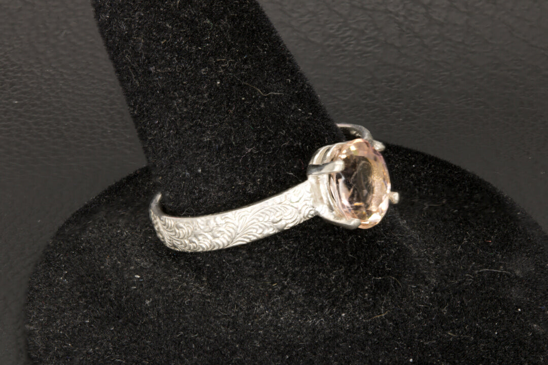 Peach Tourmaline oval facet set in a decorative sterling silver ring band left photo