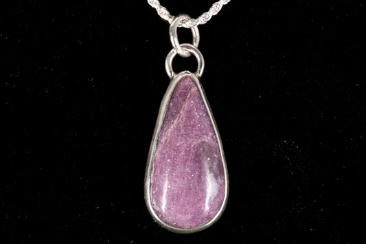 Pink Lepidolite pendant set in sterling silver on a black background front view
