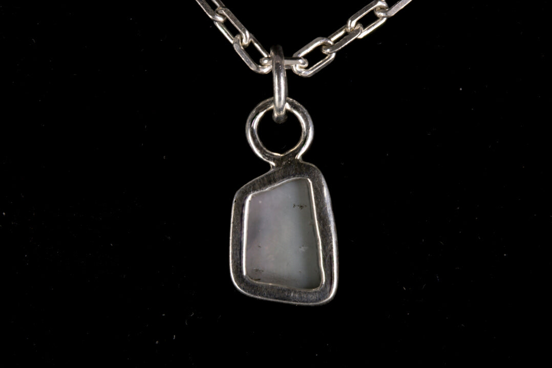 Tiger striped Australian Mintabie Opal set in sterling silver on a black background back view