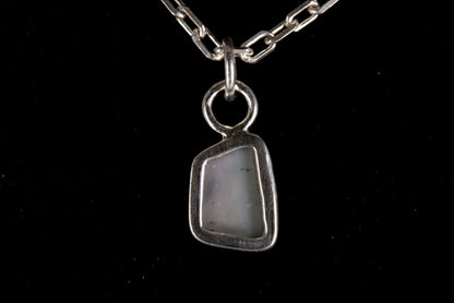 Tiger striped Australian Mintabie Opal set in sterling silver on a black background back view