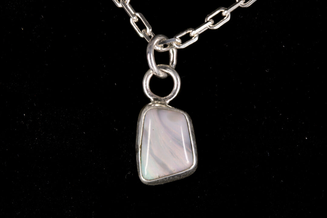 Tiger striped Australian Mintabie Opal set in sterling silver on a black background