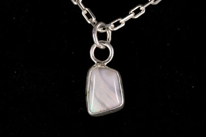 Tiger striped Australian Mintabie Opal set in sterling silver on a black background