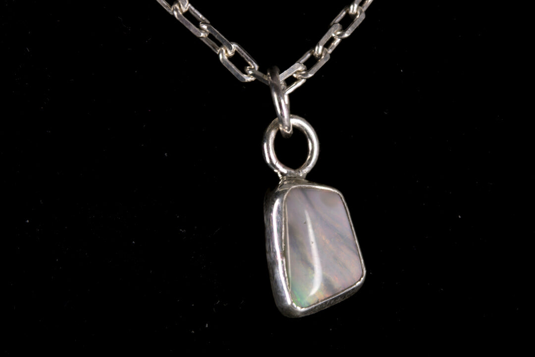 Tiger striped Australian Mintabie Opal set in sterling silver on a black background