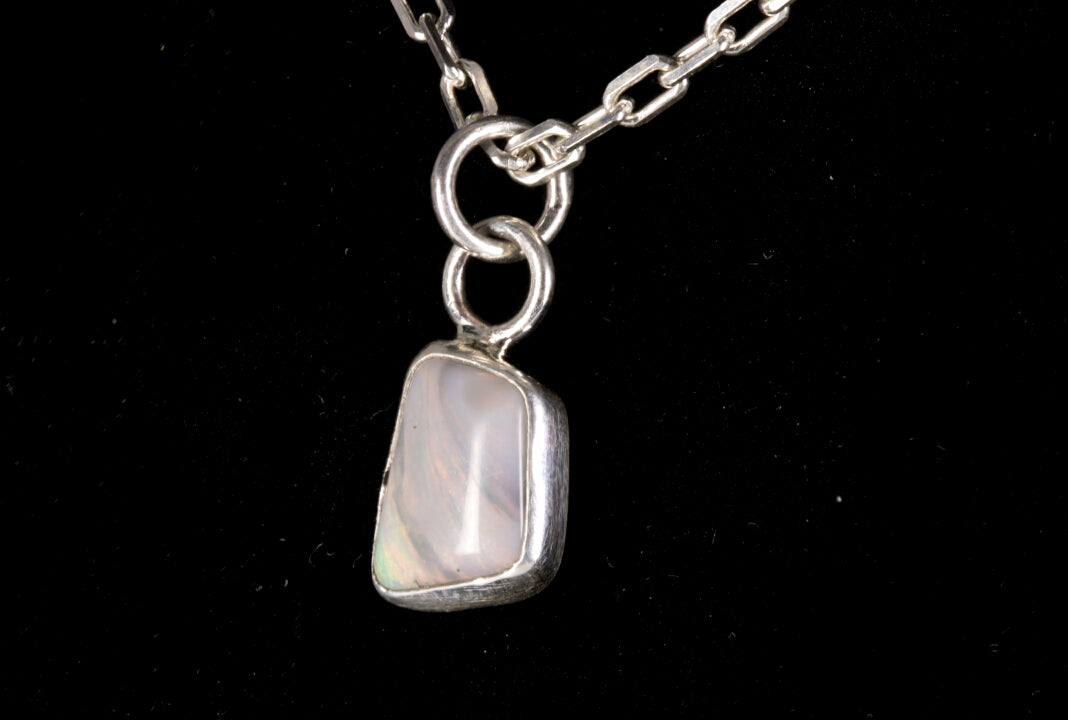 Tiger striped Australian Mintabie Opal set in sterling silver on a black background