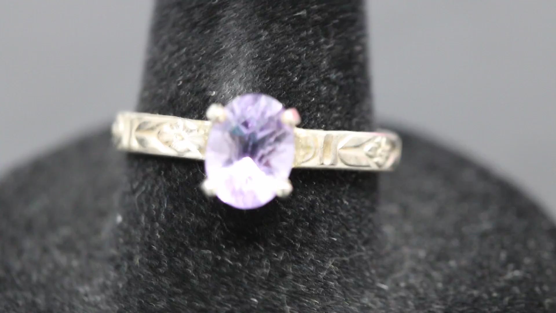 Faceted oval cut Amethyst ring set in sterling silver with a flower ring band, size 8.5 back and forth video